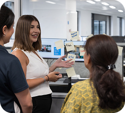 Woman presenting ideas to colleagues at work.