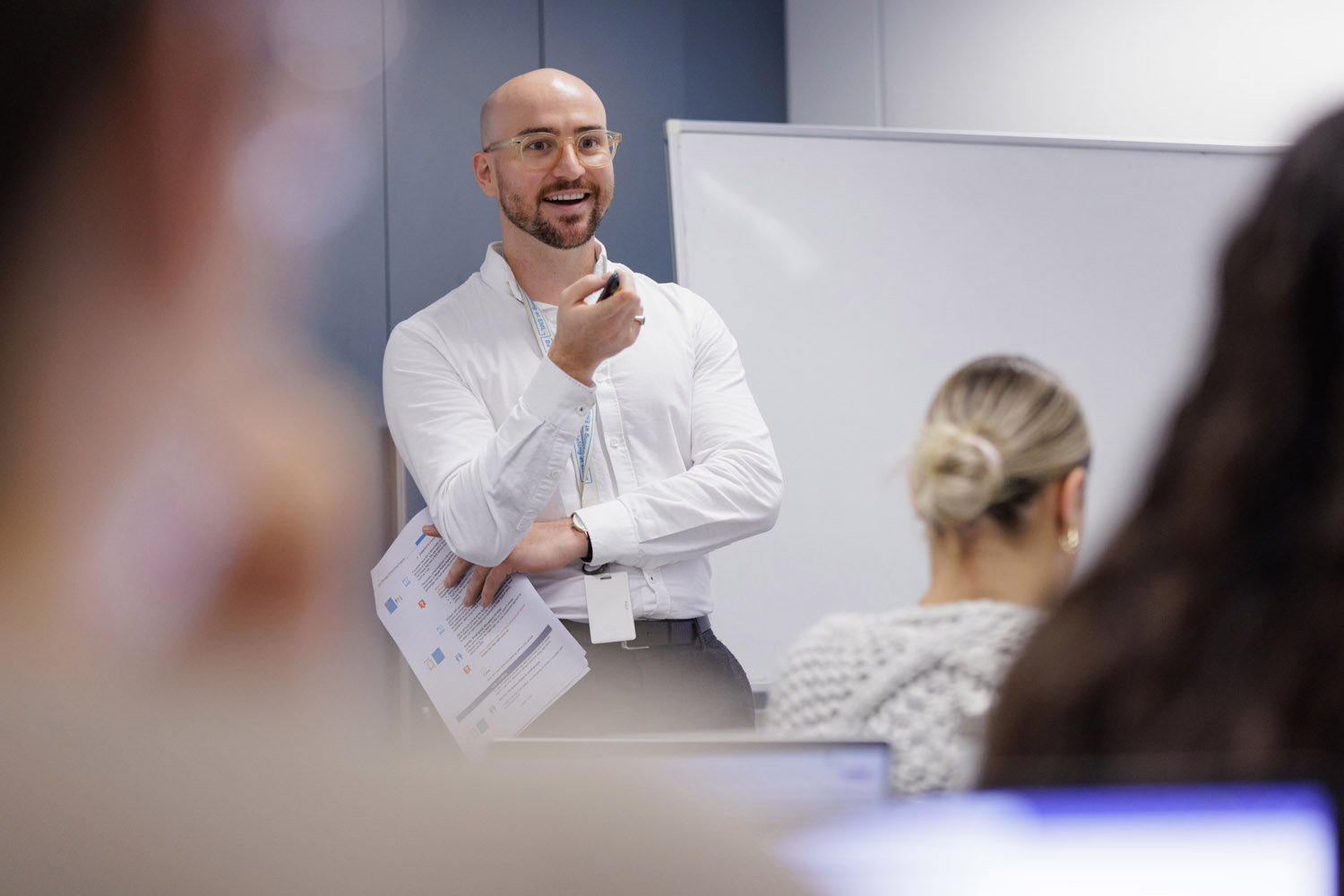 Instructor presenting in front of a classroom.