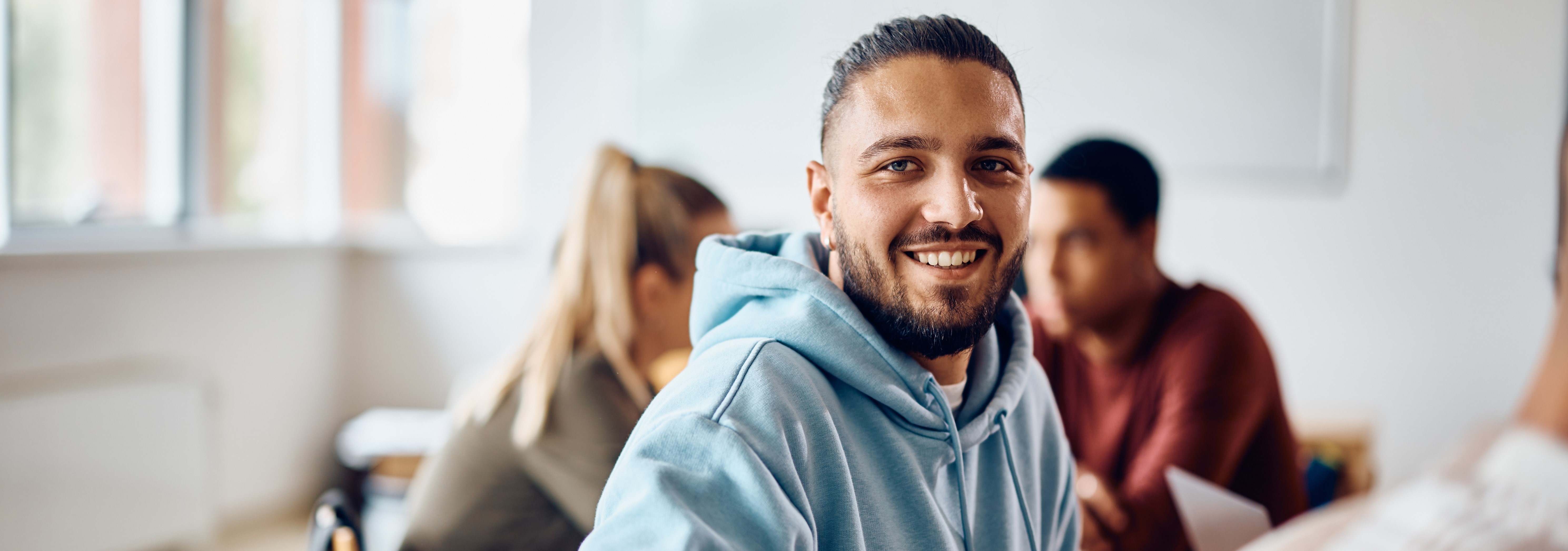 Smiling man in classroom setting
