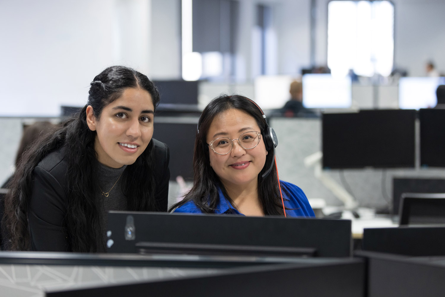 Two women working in a modern office.