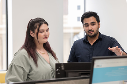 Two people discussing in an office setting.