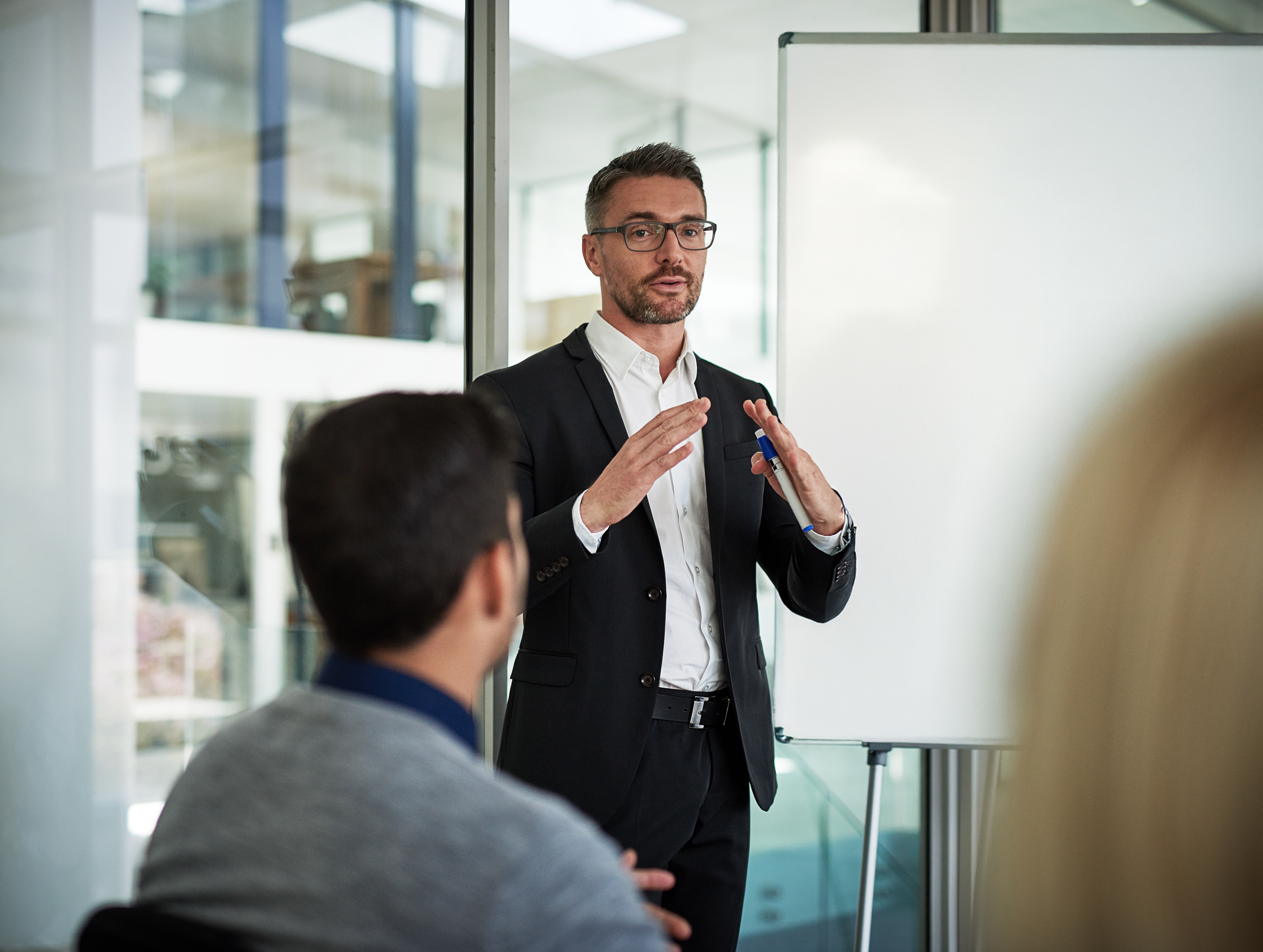 Businessman presenting in a modern conference room.