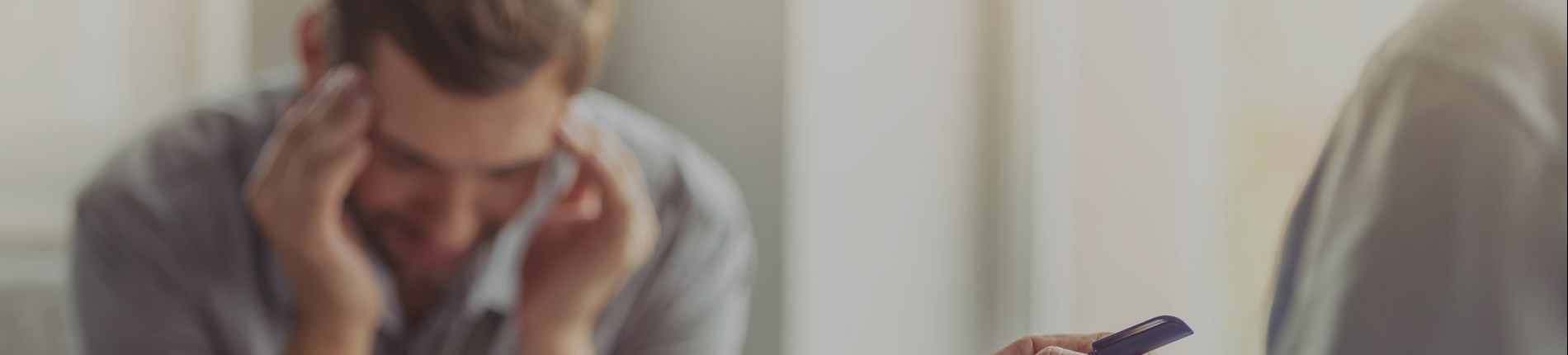 Person showing stress while using a phone.