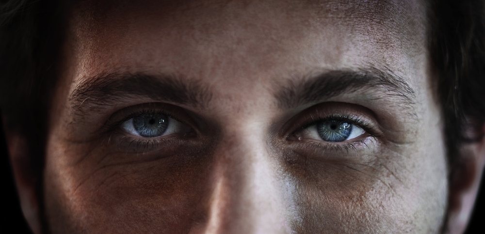 Eyes of a man closeup in studio on a dark background
