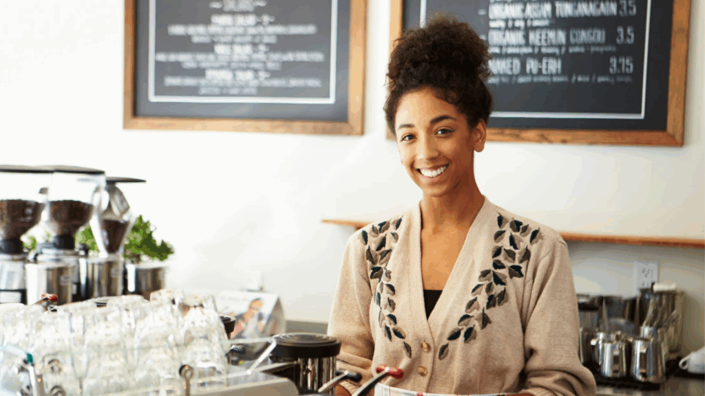 Young woman smiling working in a cafe